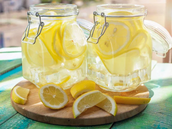 Cold Lemonade ice, in jugs, straw, urban view — Stock Photo, Image