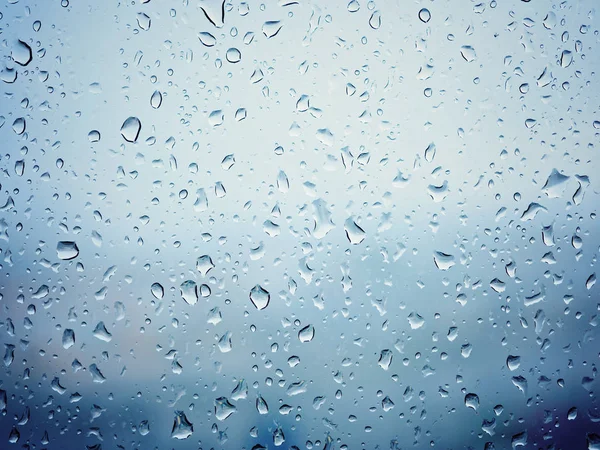 Regnet i city, vatten droppar på våta fönsterglas — Stockfoto