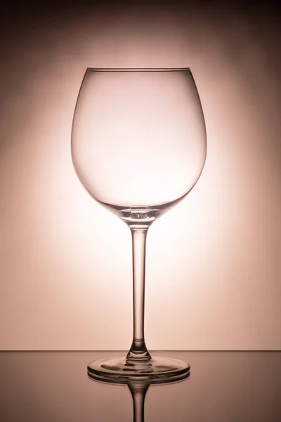 One empty wineglass for red wine on diffusion lit background — Stock Photo, Image