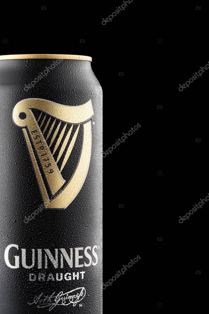 CHELYABINSK, RUSSIA - April 11,2018 Close Up of Aluminum can of Guinness draught beer with drops advertising shot on black background with realistic reflection Guinness beer one of the most successful beer brands worldwide popular Irish dry stout ori