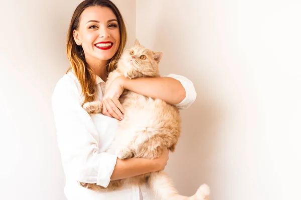 Beautiful girl with a red cat
