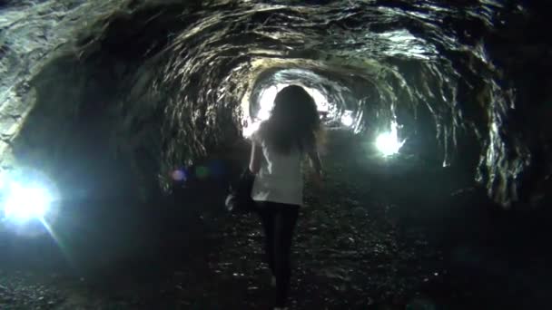 Woman walking out of a tunnel — Stock Video