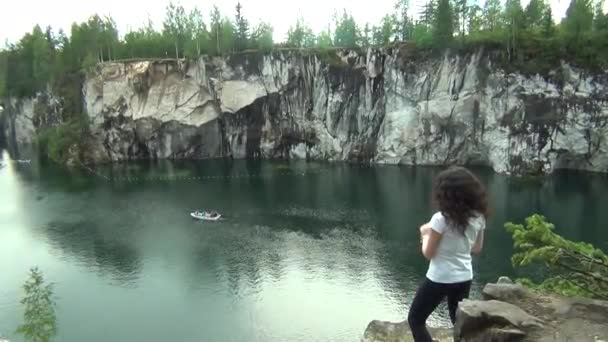 Young slim woman standing by a lake — Stock Video