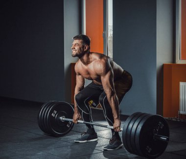 Deadlift ile ağır halter yapan Avrupa beyaz atletik erkek. adam halter kaldırma pencere karşısında. ağırlık kaldırma duygusal anlar yaşanıyor. duygusal içinde jimnastik salonu kaldırma. spor salonunda poz