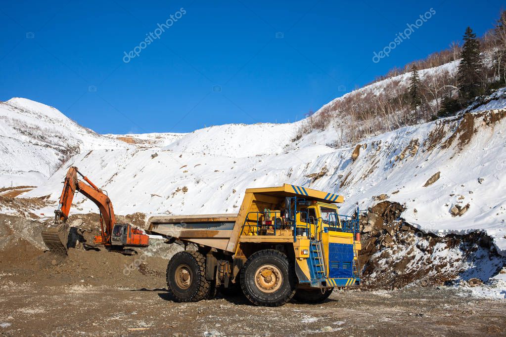 Excavator loading dump truck