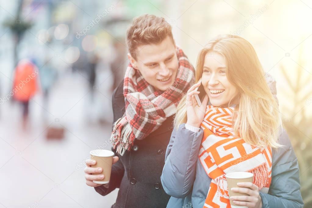 Lady with a cup of coffee to go. Girl with cup of coffee