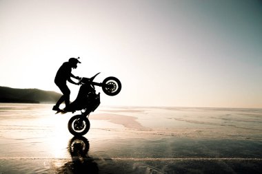 stunt rider ridin on a back wheel of motorcycle