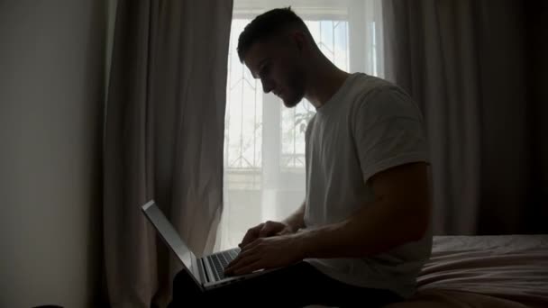 Guy Typing Laptop Sitting Bed Living Room — Stock Video