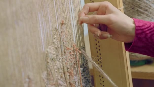 Young girl Hands Weaving Carpet Closeup, Ethnic production, 4K. Machine tool. — Stock Video