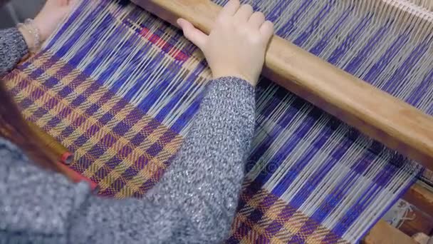 Meisje probeert witte wollen draden via draad voor loom, close-up. Weven met op weefgetouw, demonstratie van techniek. Beeldmateriaal above, 4 k. — Stockvideo