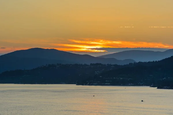 Belo pôr-do-sol dourado sobre o oceano e montanhas — Fotografia de Stock