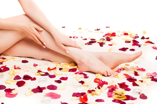 Female gentle hand laying on legs — Stock Photo, Image
