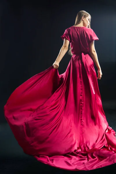 Back view of young blonde woman in bright pink dress — Stock Photo, Image