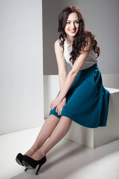 Colorful photo of a woman in white top and dark blue skirt — Stock Photo, Image