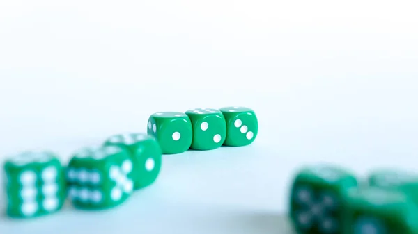 Green dices Close-up on a white background