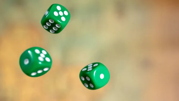 Several rolling green dice fall on a table with boardgame. Gameplay moments — Stock Photo, Image
