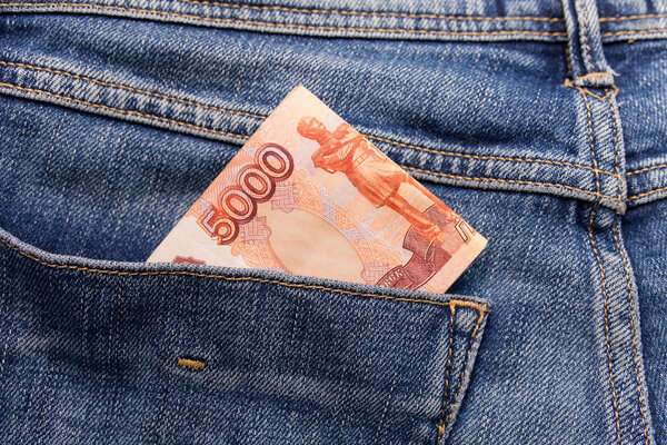 Russian money roubles in blue jeans pocket as a top view image