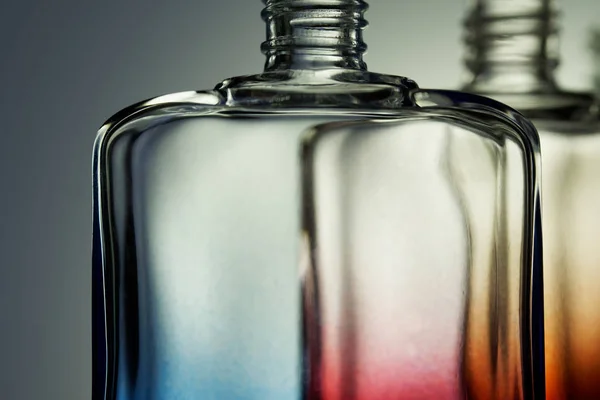 Transparent multi-colored bottles for perfume or liquids on a li