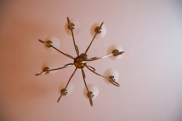 Forged vintage retro chandelier with eight shades hanging on the — Stock Photo, Image