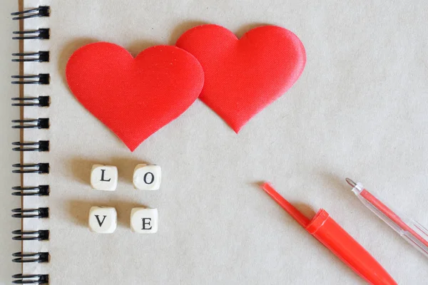 Two red silk hearts and the inscription love together with a fou — Stock Photo, Image