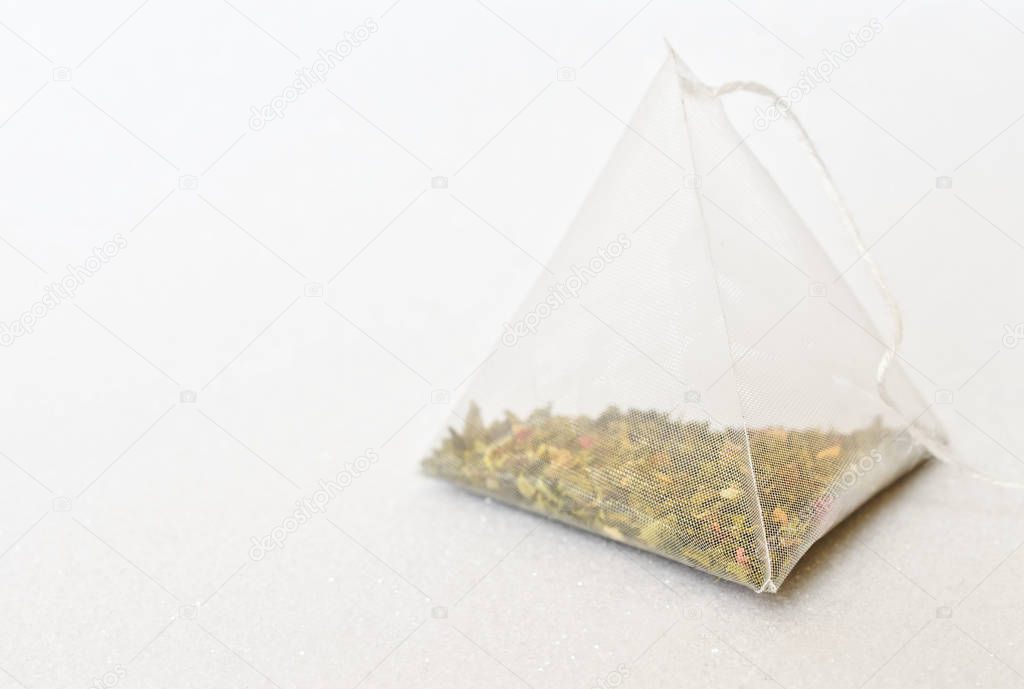One tea bag is a pyramid with green tea and aromatic fruits. Whi