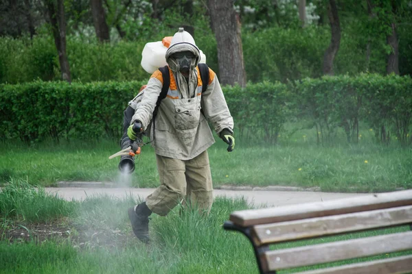 Человек Защитном Костюме Проводит Химическую Санитарную Обработку Городском Парке Распыление — стоковое фото