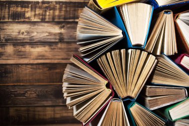 Ahşap masa, açık kitap üzerine kitaplar