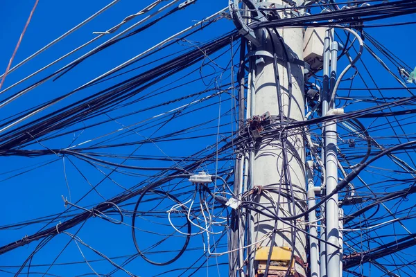 Stökiga elektriska ledningar på stolpen — Stockfoto