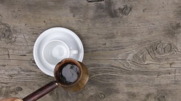 Crockery pouring freshly brewed coffee to a classic cup — Stock Video