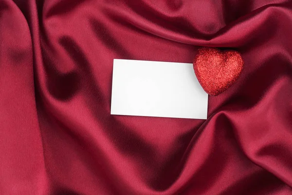 Red heart and blank white post cards, empty postcard, lies on red silk. — Stock Photo, Image