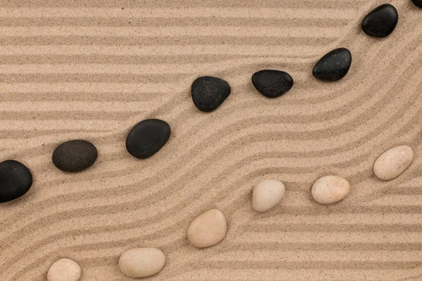 Two rows of stones lying on the sand, with space for text. — Stock Photo, Image