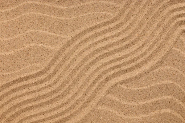 Tekstura zakrzywione linie pozostawiając wśród wydm, jako tło. — Zdjęcie stockowe
