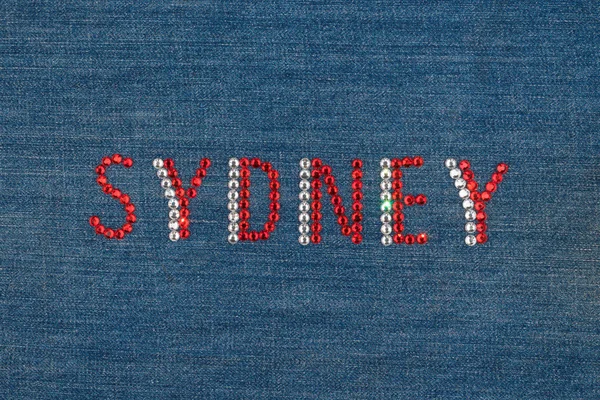 Inscription Sydney, inlaid rhinestones on denim. — Stock Photo, Image