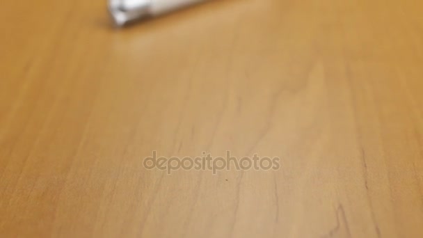 Video of white cigarette lighter on the table. Dolly shot. Close-up. — Stock Video