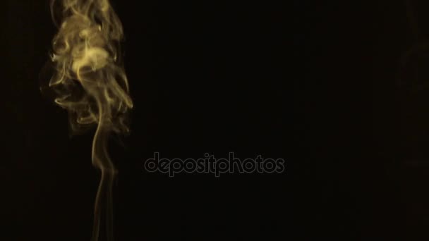 Single yellow smoke on a black background. Beautifully, — Stock Video