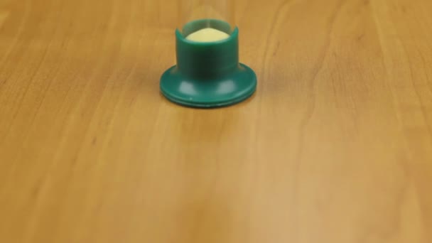 Approximation of the hourglass standing on the desktop. Dolly shot. — Stock Video