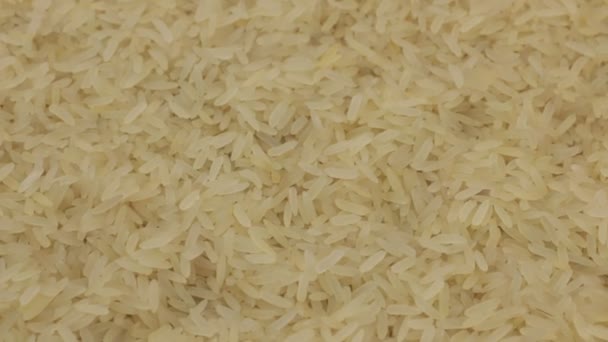 Rotación, fondo hecho de una pila de granos de arroz enteros . — Vídeo de stock