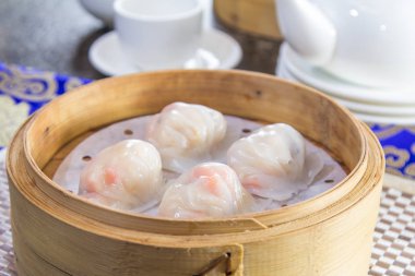 closeup of dim sum in  bamboo steamer 