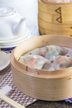 closeup of dim sum in  bamboo steamer 