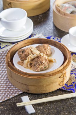 closeup of dim sum in  bamboo steamer 