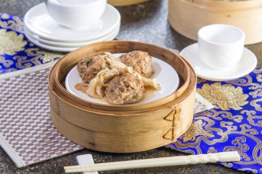 closeup of dim sum in  bamboo steamer 