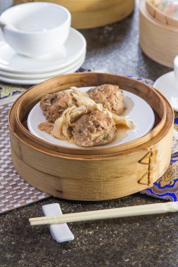 closeup of dim sum in  bamboo steamer 