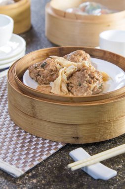closeup of dim sum in  bamboo steamer 