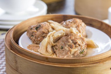 closeup of dim sum in  bamboo steamer 