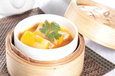 closeup of dim sum in  bamboo steamer 