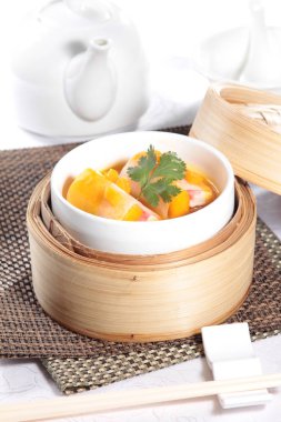 closeup of dim sum in  bamboo steamer 