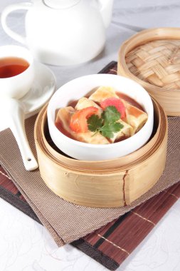 closeup of dim sum in  bamboo steamer 