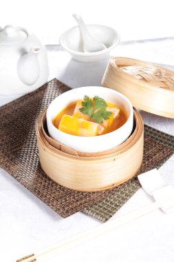 closeup of dim sum in  bamboo steamer 