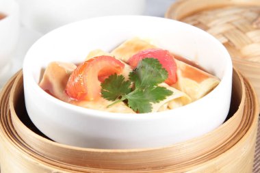 closeup of dim sum in  bamboo steamer 