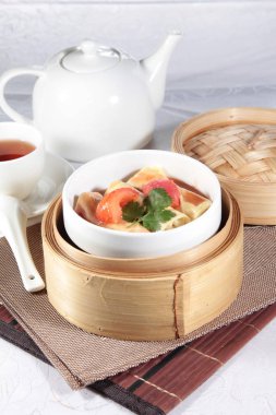closeup of dim sum in  bamboo steamer 